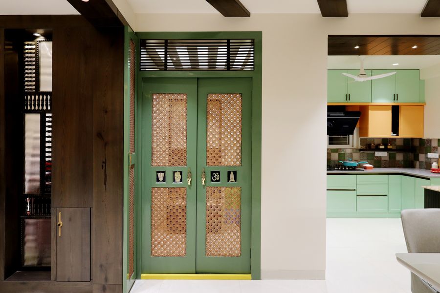 A traditional Indian home entrance with an intricately carved wooden door