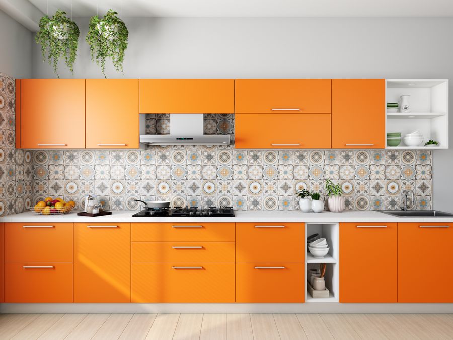A vibrant modular kitchen with patterned tile backsplash and warm cabinetry