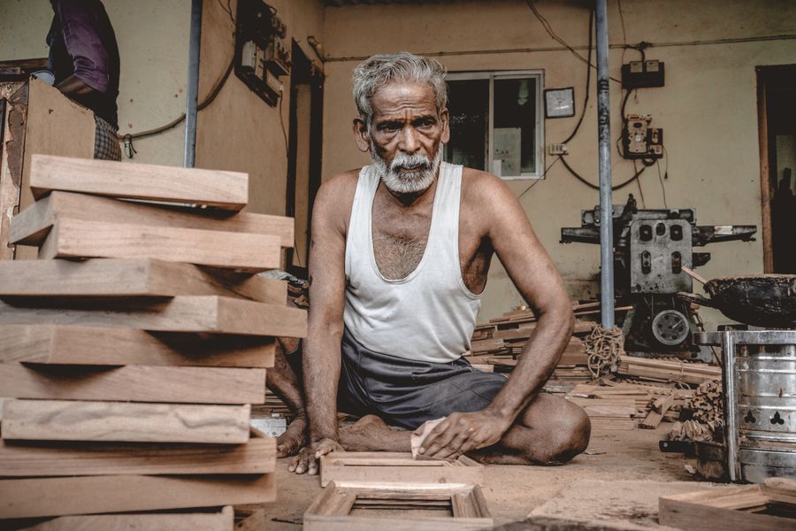 A senior craftsman at woodwork in the carpentry workshop
