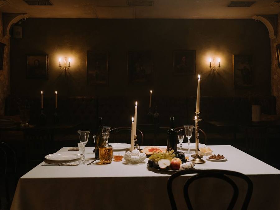 Candle-lit private dining table in a dark room