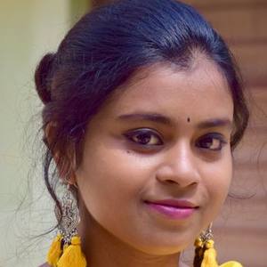 Young Indian woman with yellow earrings smiling