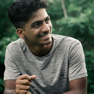 Smiling young Indian man in a grey t-shirt