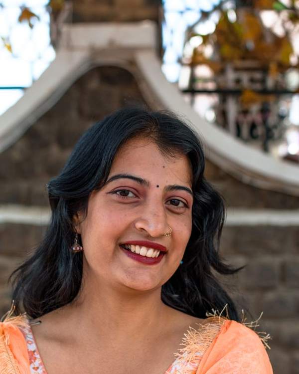 Smiling young Indian woman in a peach kurta