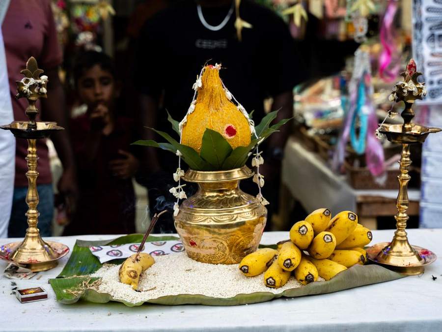 Brass lamp and banana offerings arranged on a banana leaf for a puja