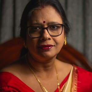 Mature Indian woman in a red saree with glasses