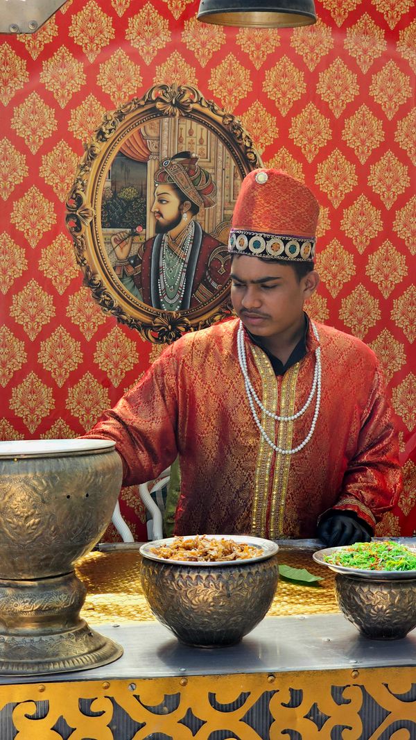 Ustad Rahim Qureshi in traditional attire preparing Awadhi cuisine