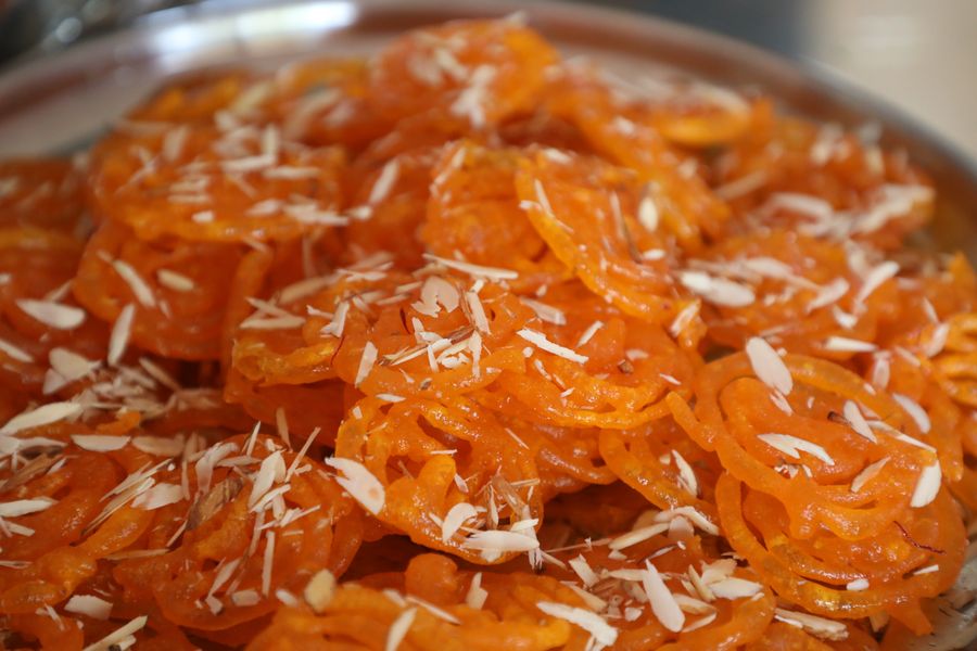 Fresh jalebi topped with almond slivers from the mithai studio