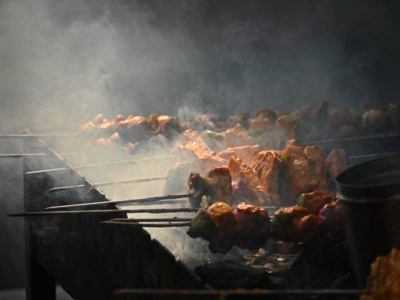 Kebabs searing on a smoky charcoal grill