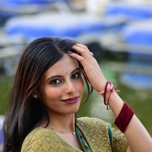 Young Indian woman in a patterned saree smiling