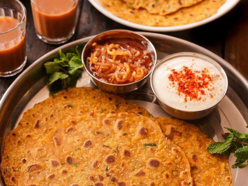 Breakfast thali of parathas with curd, chole and clay cups of chai