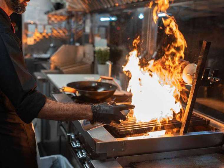 Flames leaping from a kadhai in the dhaba kitchen