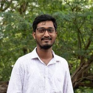 Young Indian man with glasses in a white shirt