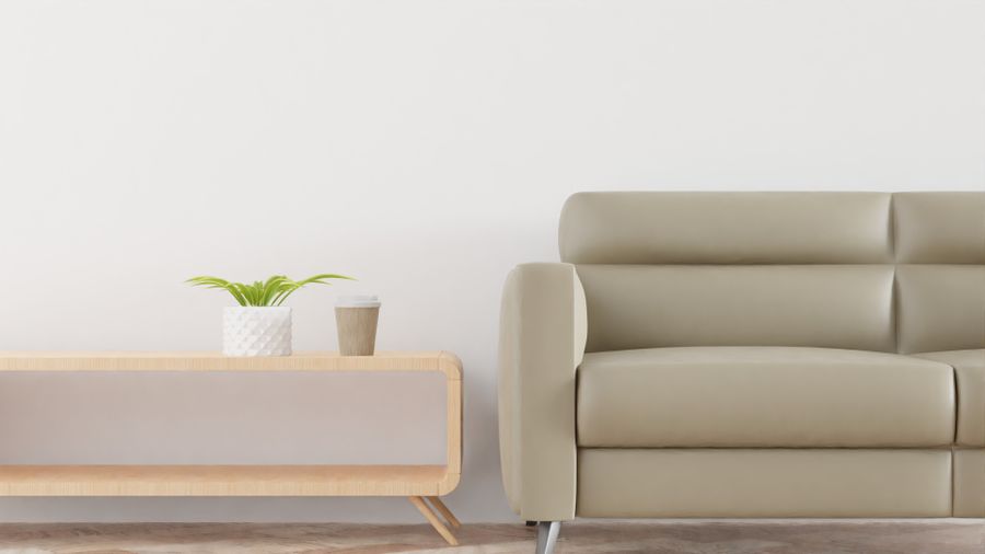 A spotless modern living room with a beige sofa after deep cleaning