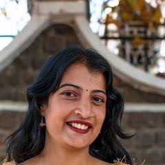 Young Indian woman smiling, photographed outdoors