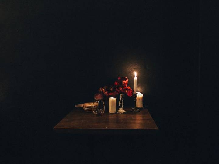 A single candle-lit table set for dinner