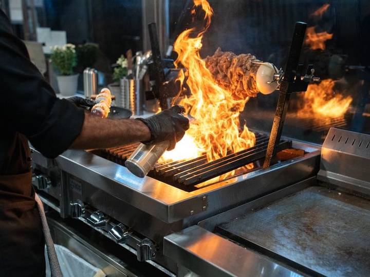 Flames rising from a charcoal grill in the kitchen