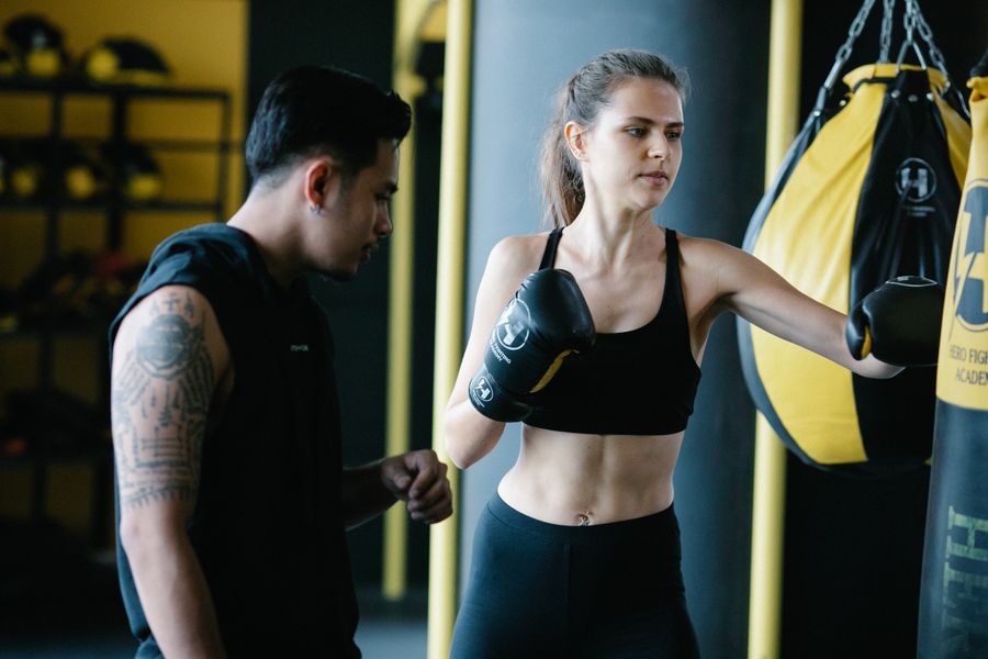 A boxer driving punches into a heavy bag during training