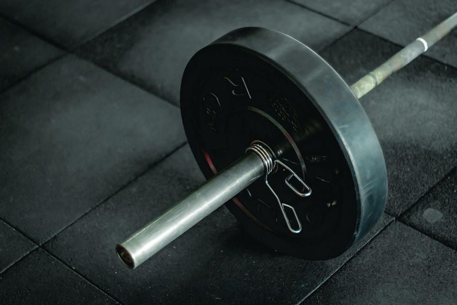 Close-up of heavy plates on a barbell on the platform