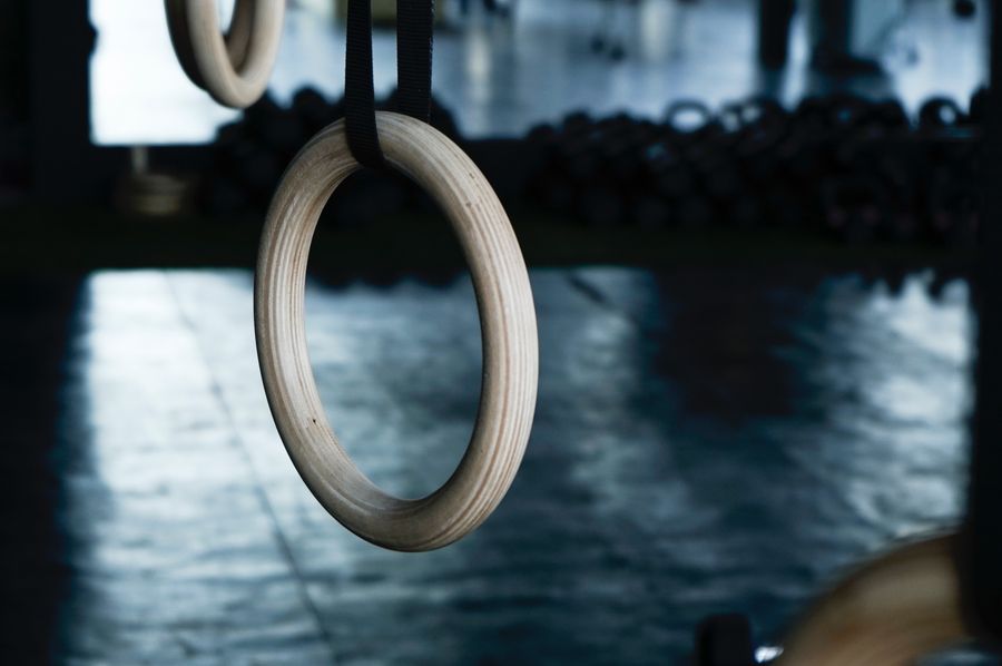 Gymnastic rings hanging in the dimly lit rig area