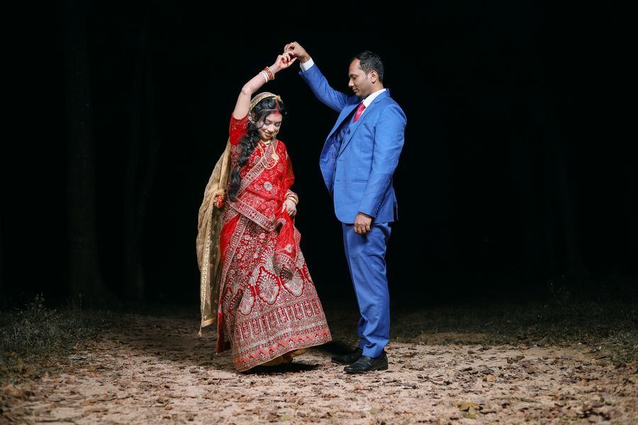 A couple dancing at a nighttime Indian wedding celebration
