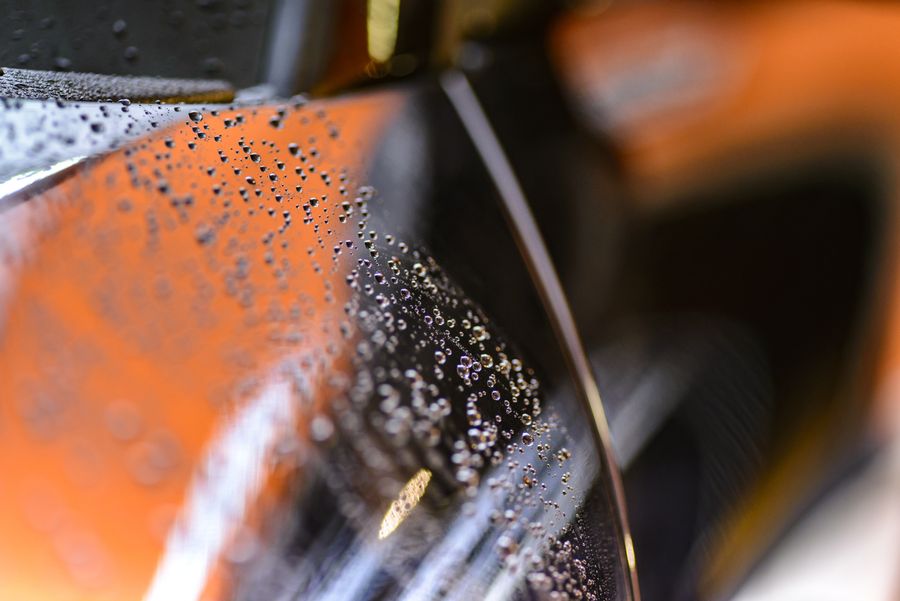 Water beading tightly on a ceramic-coated glossy panel