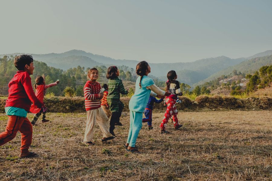A joyful group of kids playing together outdoors on a sunny day