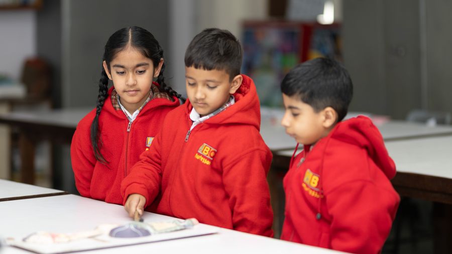 Preschool children engaged in a classroom learning activity with their educator