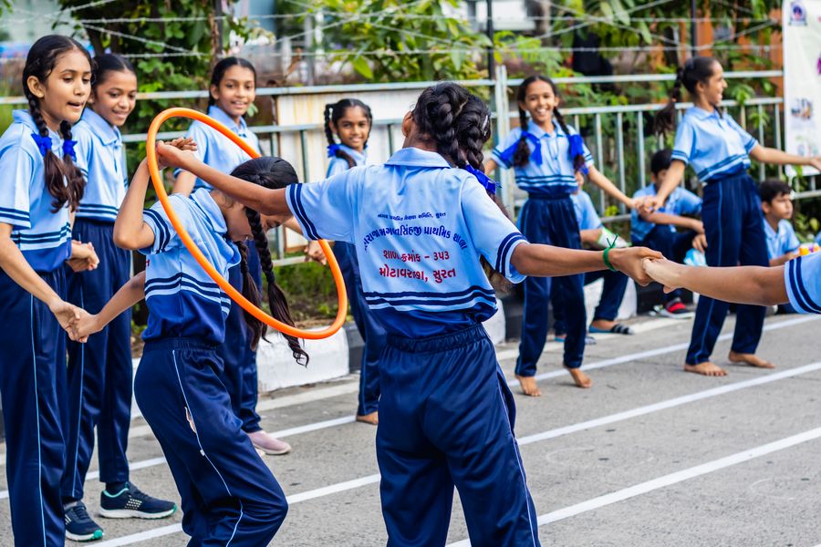 Children playing hula-hoop games on the Gubbara outdoor play field