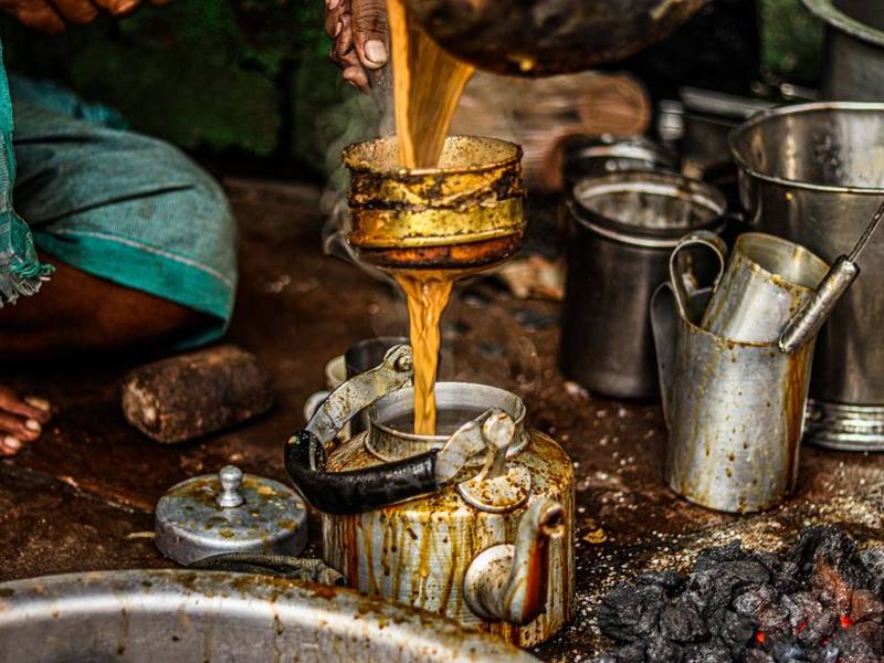 Chai being poured from a height at a street tea stall