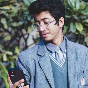 Young Indian man in glasses and a blazer