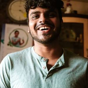 Laughing Indian man in a green shirt