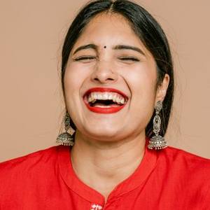 Laughing Indian woman in a red kurta