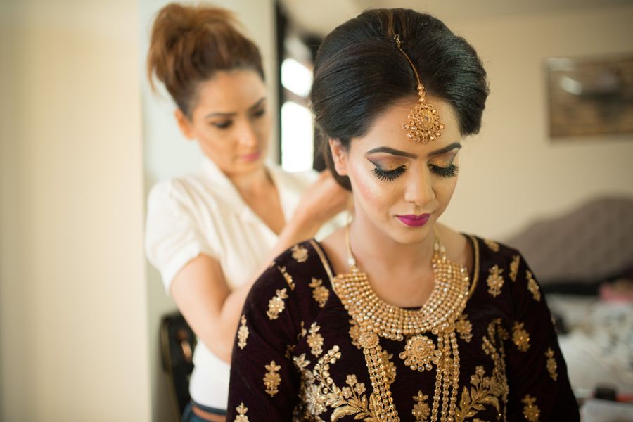 A bride being dressed and styled by the Kaaya bridal studio
