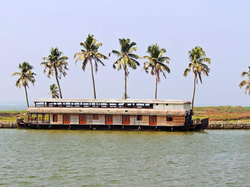 Houseboat and coconut palms on the Kerala backwaters