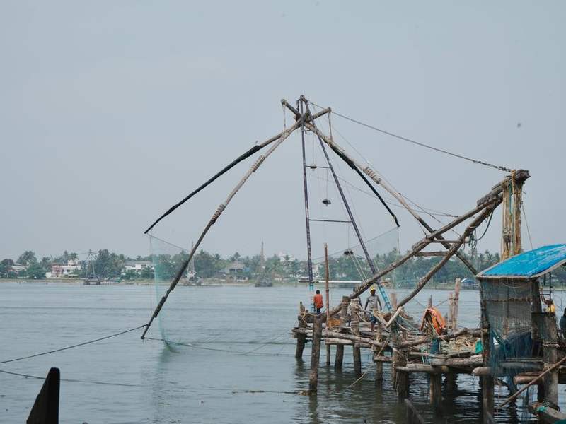 Chinese fishing nets on the Fort Kochi shore at dusk