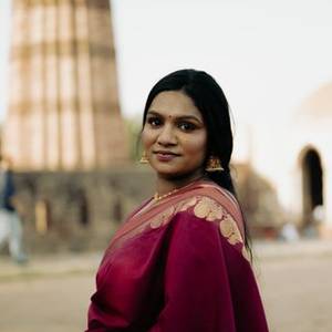 Smiling Indian woman in a maroon saree