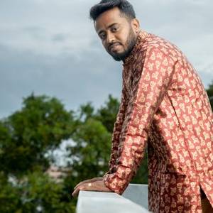 Indian man in a printed kurta smiling
