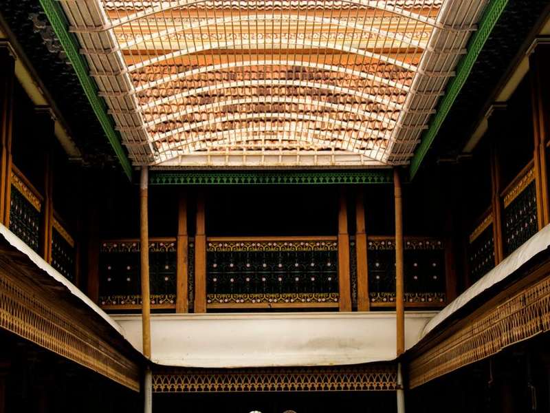 Carved wooden ceiling and pillars of a heritage Chettinad hall