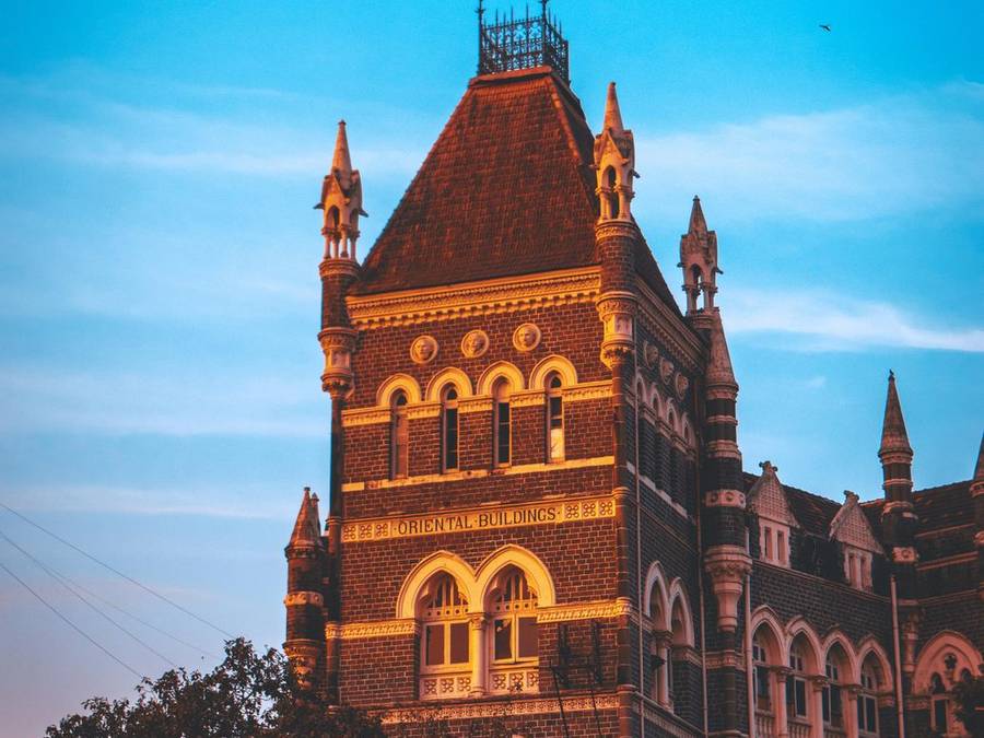 Victorian Gothic heritage building in Mumbai against a blue evening sky