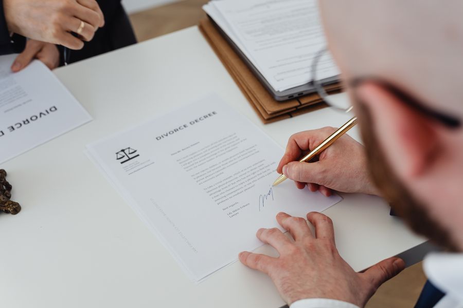 A matrimonial decree being signed at a desk