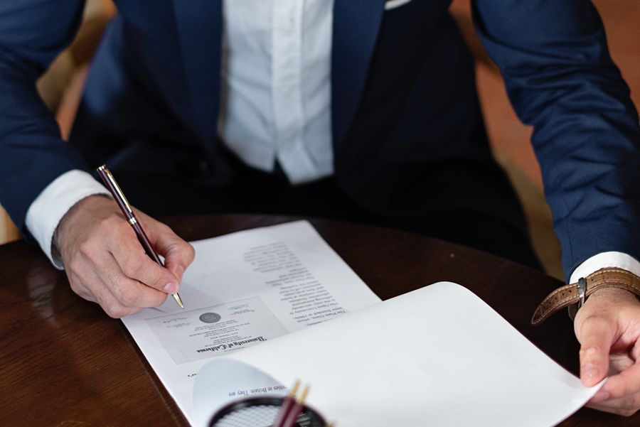 A professional reviewing and signing startup incorporation documents