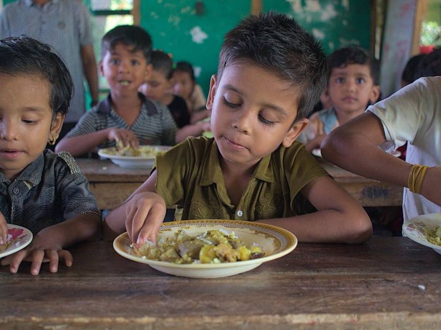 Indian children eating sweets together