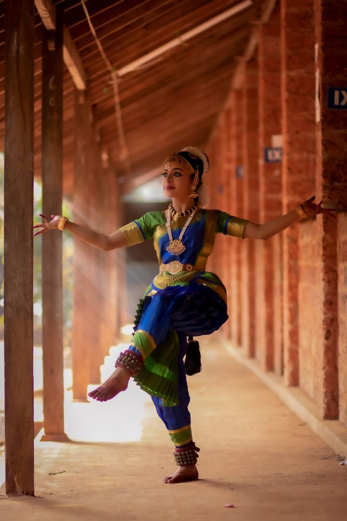Guru Anjali Bose performing classical dance in warm stage light