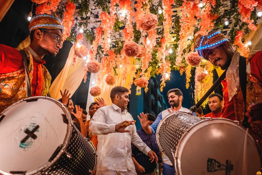 An energetic Indian wedding celebration with drummers and dancing guests