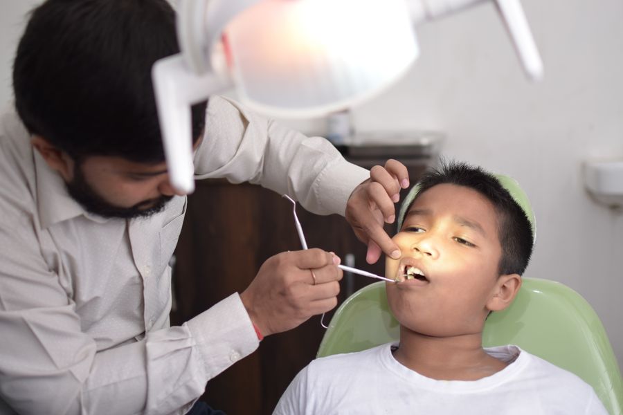 A young boy having a comfortable dental check-up with a gentle dentist