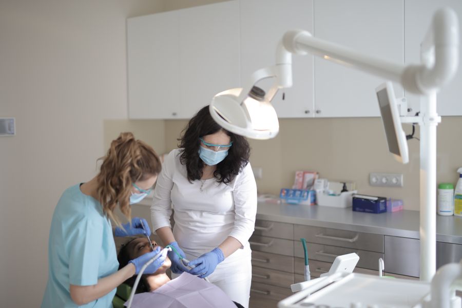 A dentist and assistant performing a precise, calm root canal procedure
