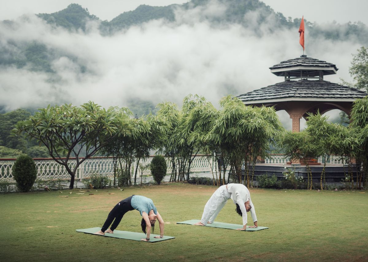 An outdoor yoga session at the Prana ashram with the Himalayan foothills behind