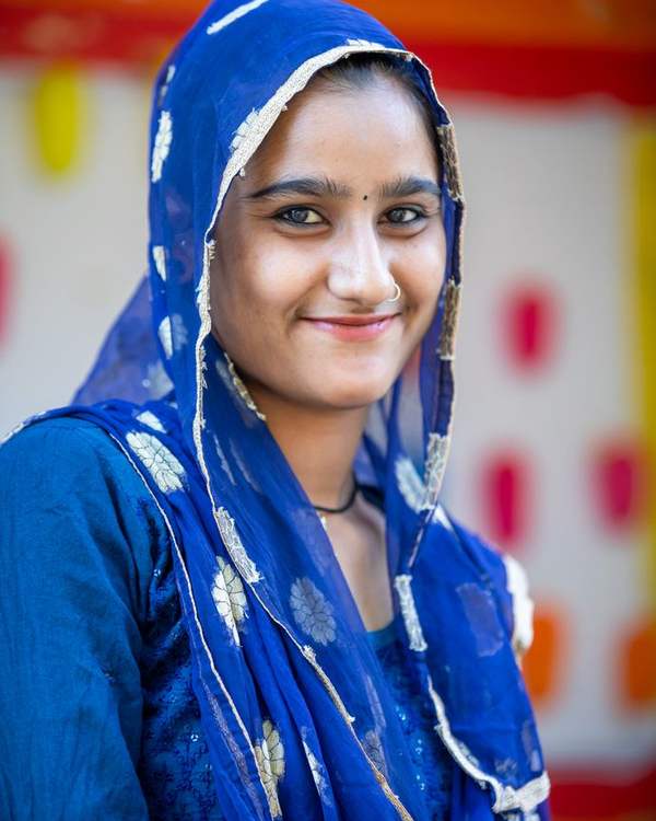 Smiling young Indian woman in a blue embroidered odhni