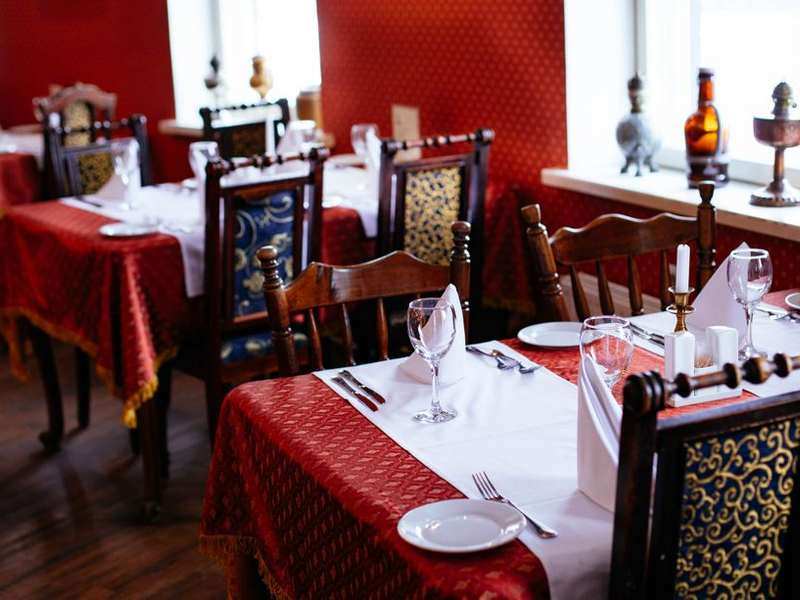 Indian restaurant dining hall with red tablecloths and lanterns