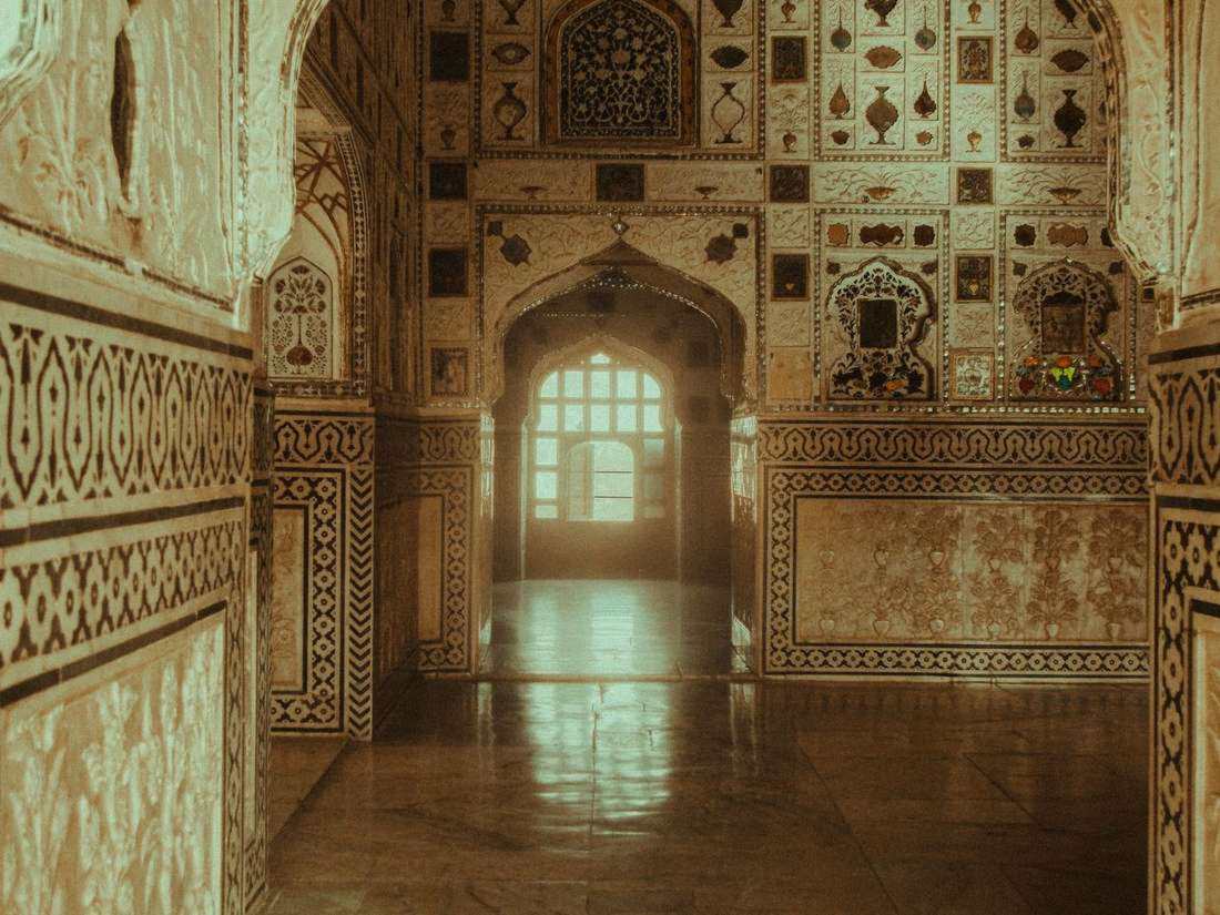 Ornate pillared courtyard of a Jaipur palace with painted arches